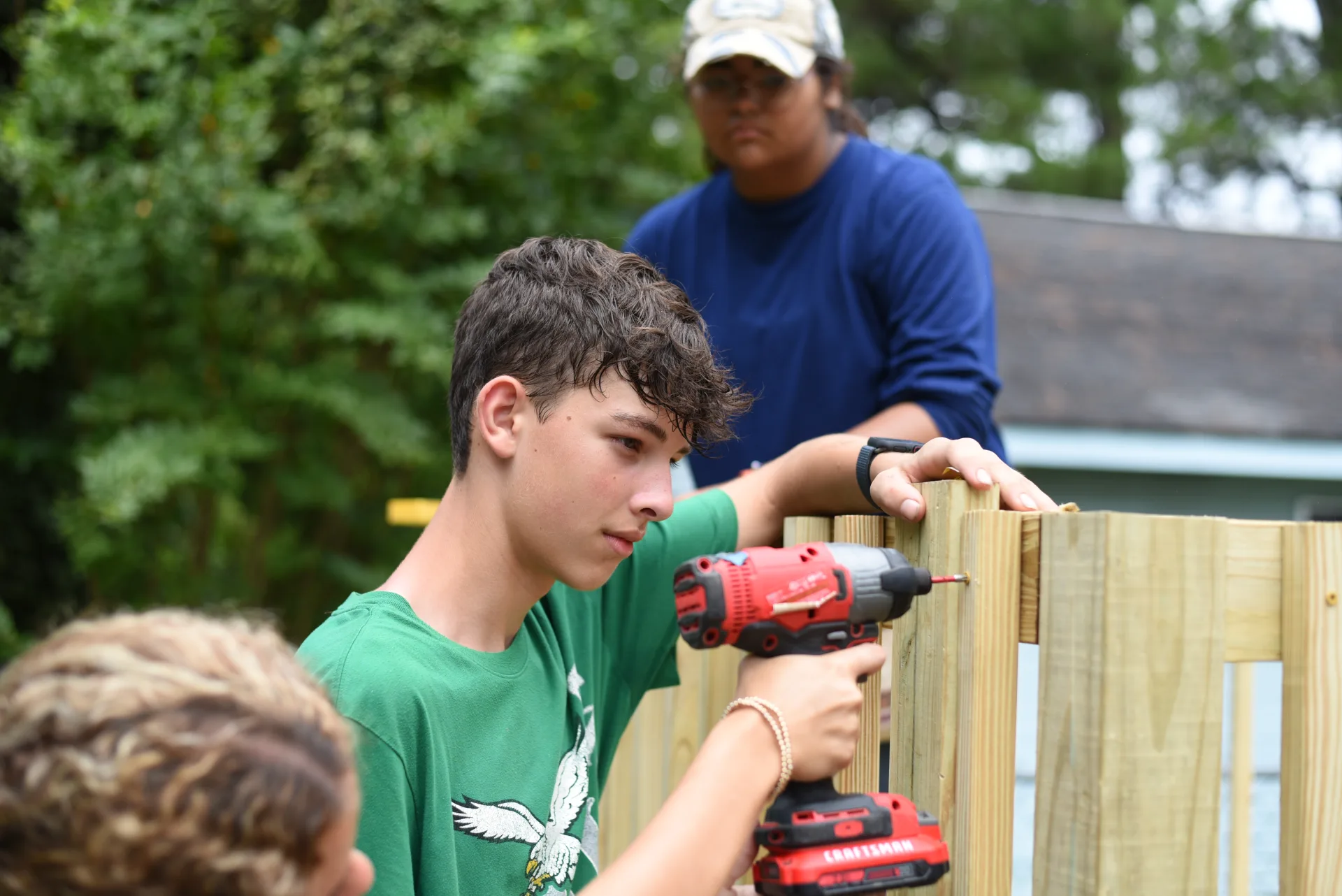 Student drilling fence
