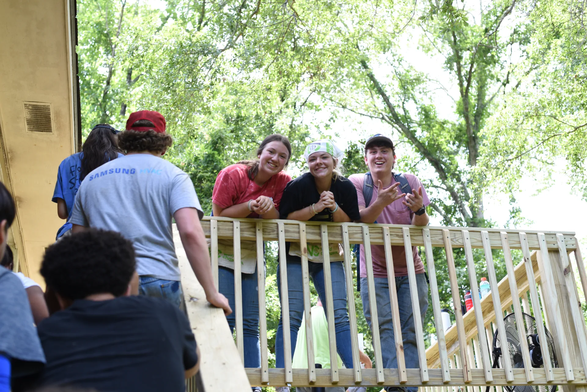 Students on completed deck in lush green setting